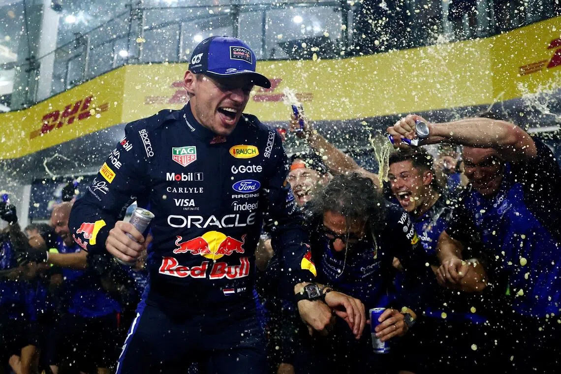 Red Bull’s Max Verstappen celebrating with his teammates after winning the Bahrain Grand Prix at Malaysia’s Sepang International Circuit on Oct 4.